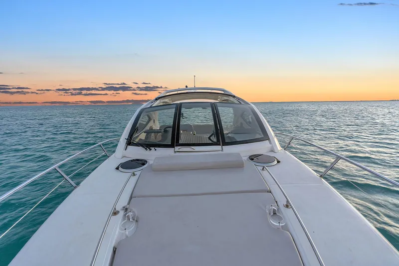 Slide: The Image of Schaefer 375 yacht cruising at sunset, 2023 model, on calm ocean waters. - 17