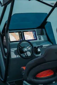 Slide: The Image of 2025 Highfield ADV7 boat cockpit with modern navigation screens and steering wheel. - 2