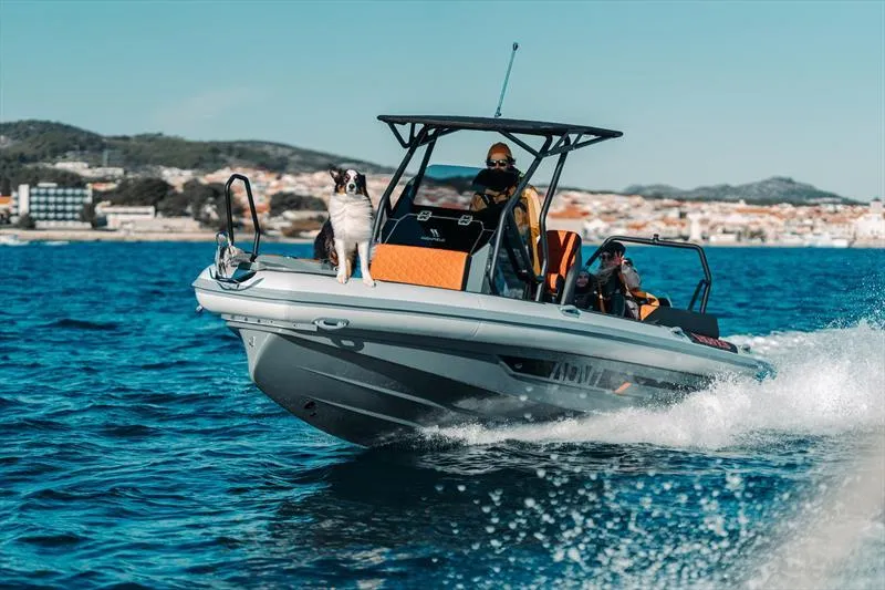 Slide: The Image of 2025 Highfield ADV7 boat cruising with passengers and a dog on a sunny day. - 6