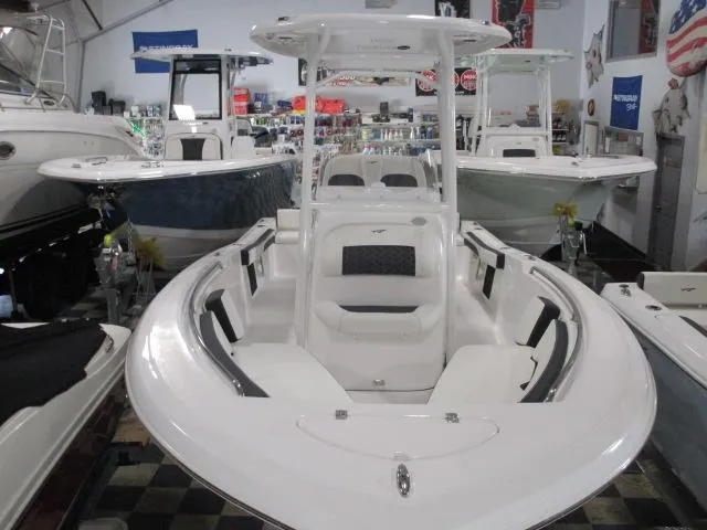 The Image of 2025 Tidewater 198 CC Adventure boat in showroom, featuring sleek white design and spacious seating. - 1