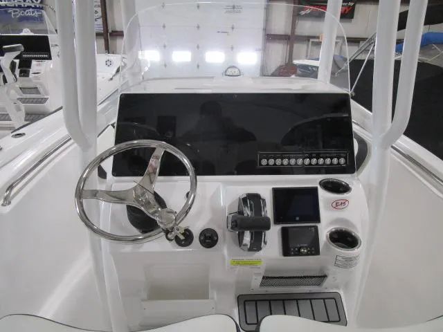 Slide: The Image of 2025 Tidewater 198 CC Adventure boat dashboard with steering wheel and controls. - 11