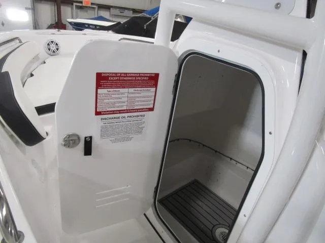 Slide: The Image of 2025 Tidewater 198 CC Adventure boat storage compartment with open door. - 12