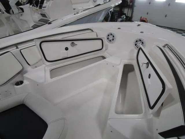 Slide: The Image of 2025 Tidewater 198 CC Adventure boat interior with open storage compartments and speakers. - 13
