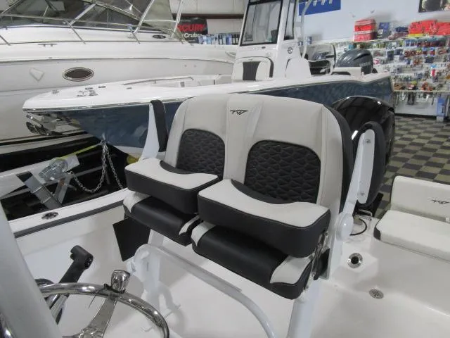 Slide: The Image of 2025 Tidewater 198 CC Adventure boat interior with dual seats in showroom. - 16