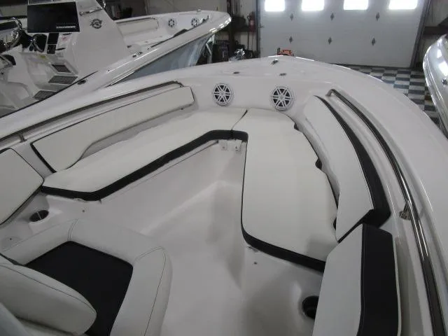 Slide: The Image of 2025 Tidewater 198 CC Adventure boat interior with cushioned seating and speakers. - 6