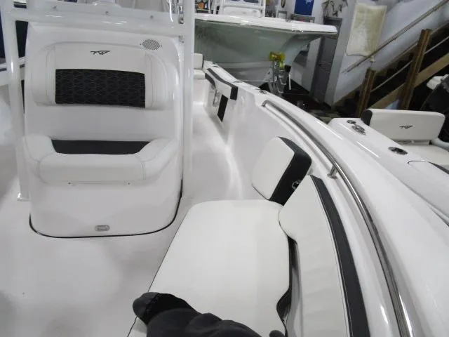 Slide: The Image of 2025 Tidewater 198 CC Adventure boat interior with white seating and sleek design. - 9