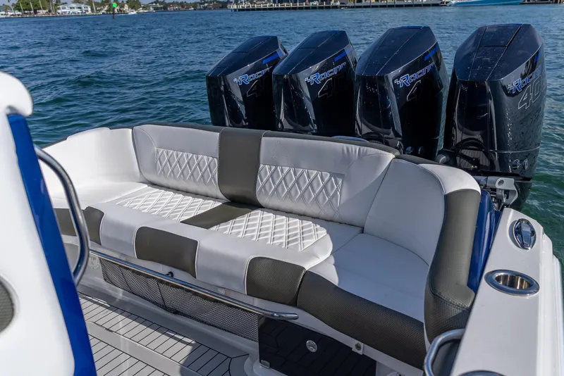 Slide: The Image of 2024 Nor-Tech 390 Sport boat with luxurious seating and powerful engines on the water. - 12