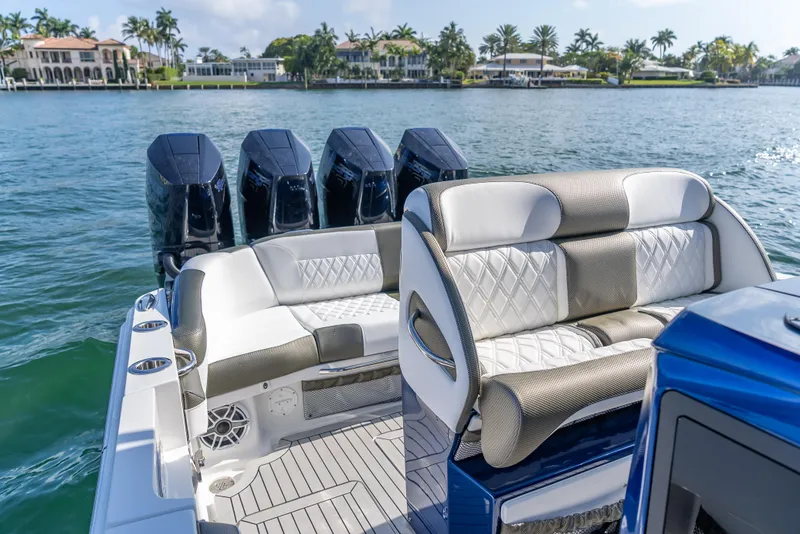 Slide: The Image of 2024 Nor-Tech 390 Sport boat with luxurious seating and powerful engines on a scenic waterway. - 15