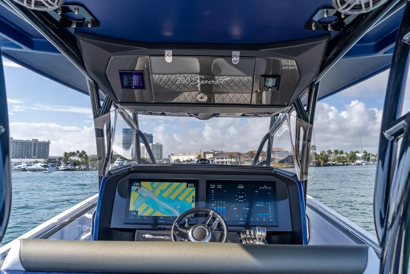 Slide: The Image of 2024 Nor-Tech 390 Sport boat dashboard with navigation display on open water. - 16