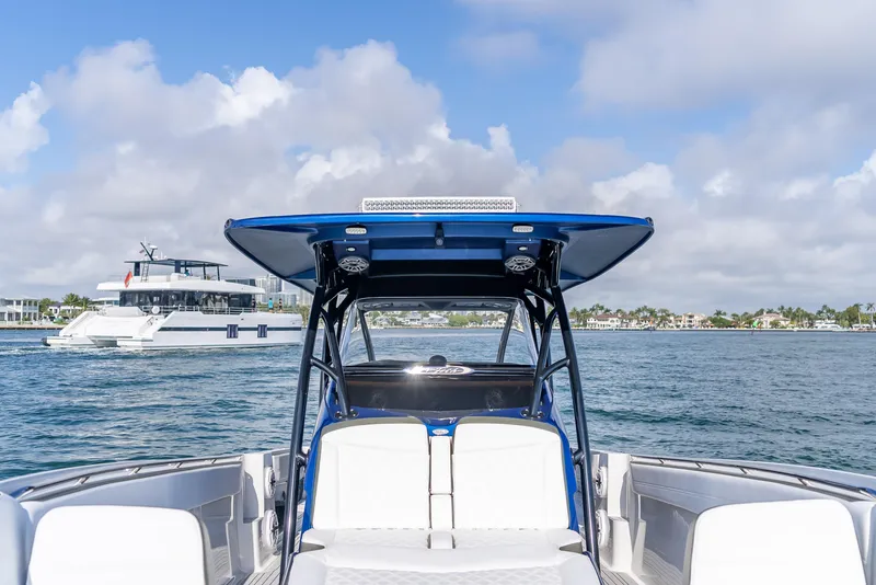 Slide: The Image of 2024 Nor-Tech 390 Sport boat on water, featuring sleek design and spacious seating. - 25