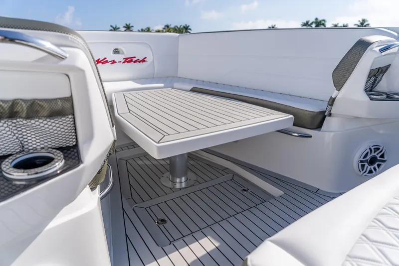 Slide: The Image of 2024 Nor-Tech 390 Sport boat interior with sleek seating and modern table design. - 3