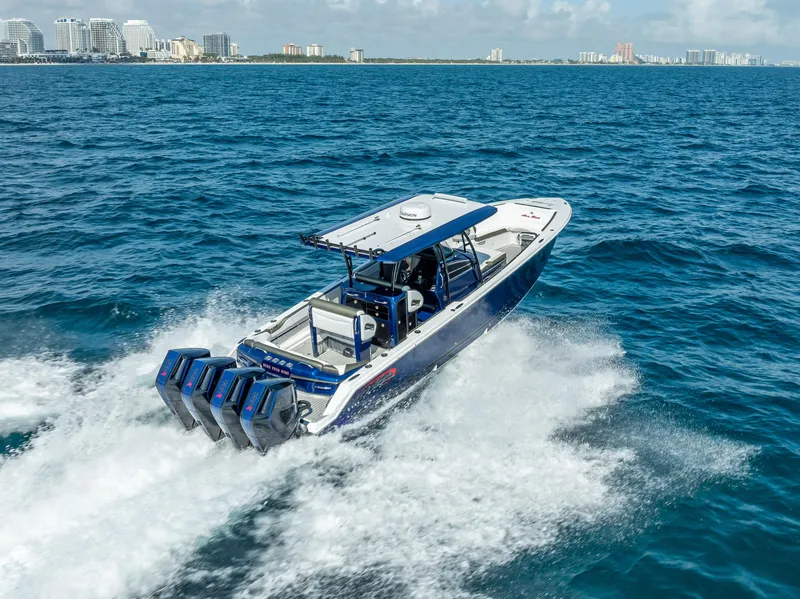 Slide: The Image of 2024 Nor-Tech 390 Sport boat cruising on open water, showcasing powerful engines. - 37