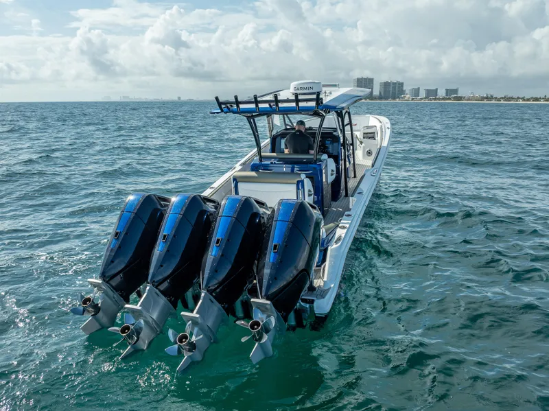 Slide: The Image of 2024 Nor-Tech 390 Sport boat with four powerful engines cruising on open water. - 38