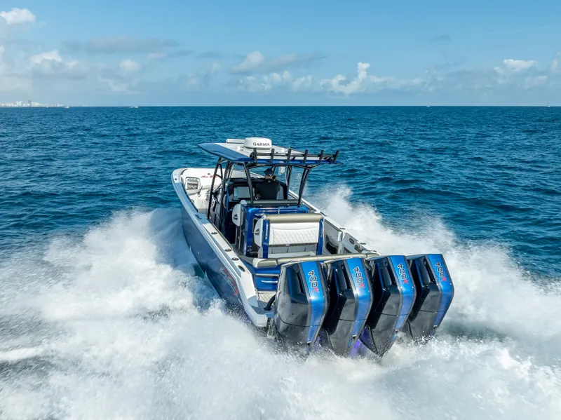 Slide: The Image of 2024 Nor-Tech 390 Sport boat cruising on open ocean with powerful engines. - 4