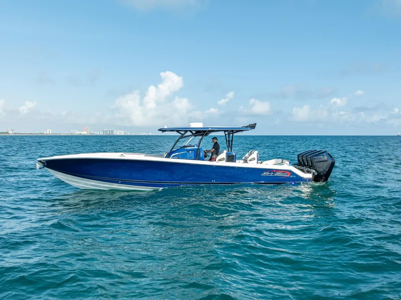 Slide: The Image of 2024 Nor-Tech 390 Sport boat cruising on open water under a clear blue sky. - 42