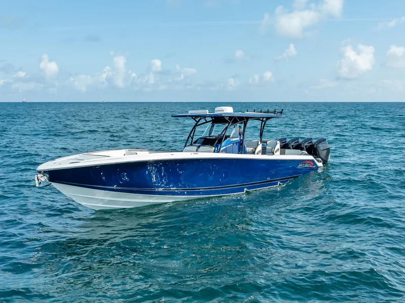 Slide: The Image of 2024 Nor-Tech 390 Sport boat on open water, featuring a sleek blue design. - 43
