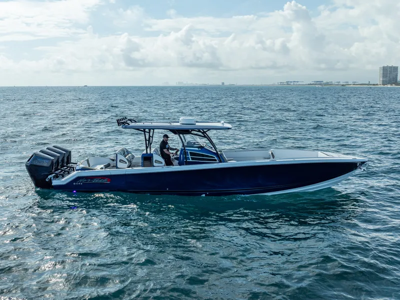 Slide: The Image of 2024 Nor-Tech 390 Sport boat cruising on open water under a cloudy sky. - 47