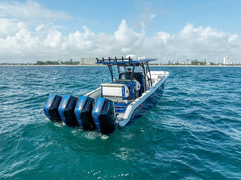 Slide: The Image of 2024 Nor-Tech 390 Sport boat with four engines on open water. - 49