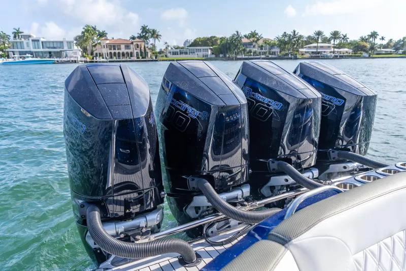 Slide: The Image of 2024 Nor-Tech 390 Sport boat with four powerful outboard engines on a sunny day. - 5
