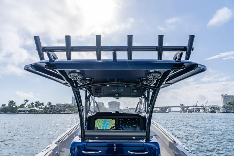 Slide: The Image of 2024 Nor-Tech 390 Sport boat on water, featuring advanced navigation system and sleek design. - 8