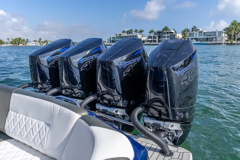 Slide: The Image of 2024 Nor-Tech 390 Sport boat with four powerful outboard engines on the water. - 9