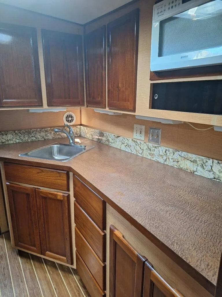 Slide: The Image of 1970 Hatteras 45 Sportfish kitchen with wooden cabinets and countertop. - 14