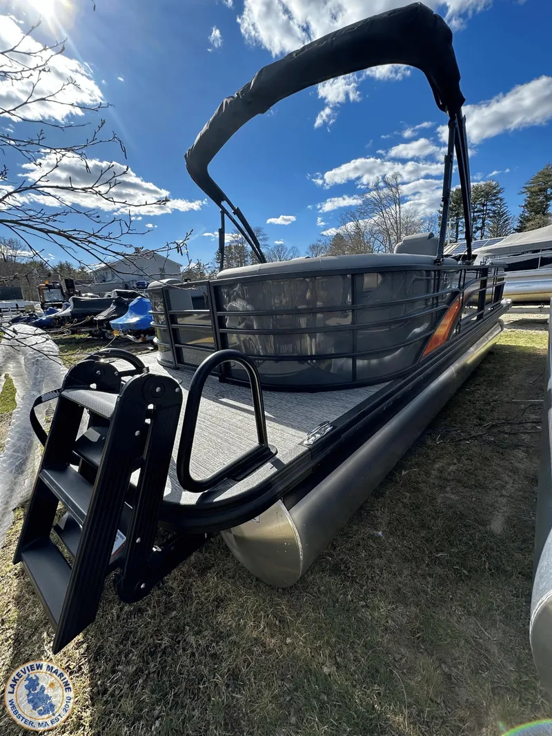 Slide: The Image of 2024 Bennington 23 LSR pontoon boat under a clear blue sky. - 2