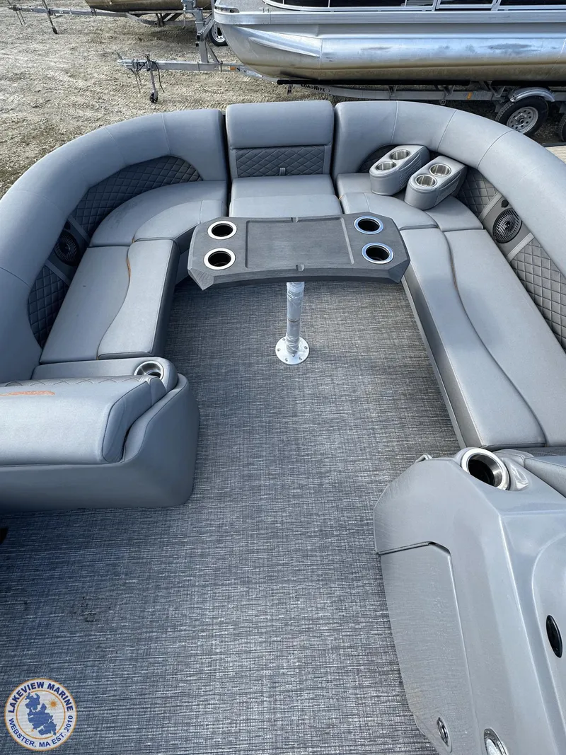 Slide: The Image of 2024 Bennington 23 LSR pontoon boat interior with gray seating and table. - 4