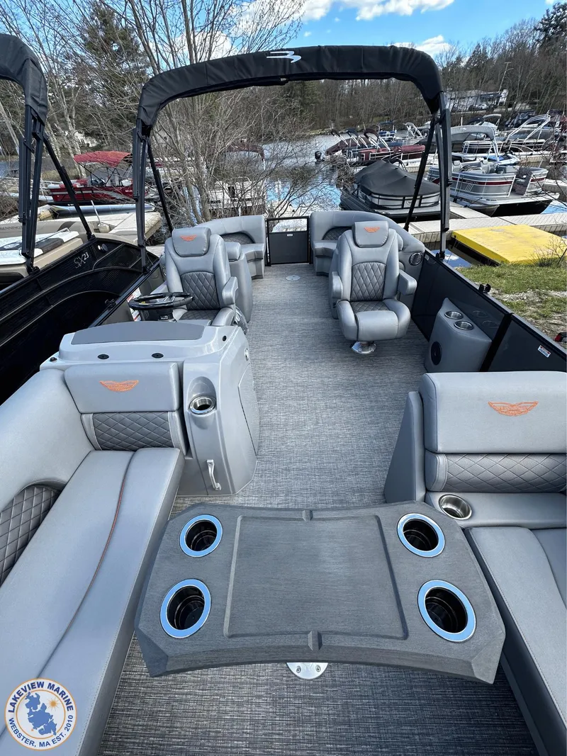 Slide: The Image of 2024 Bennington 23 LSR pontoon boat interior with luxurious seating and cup holders. - 5