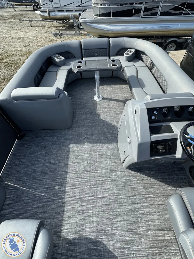 Slide: The Image of 2024 Bennington 23 LSR pontoon boat interior with gray seating and helm. - 6