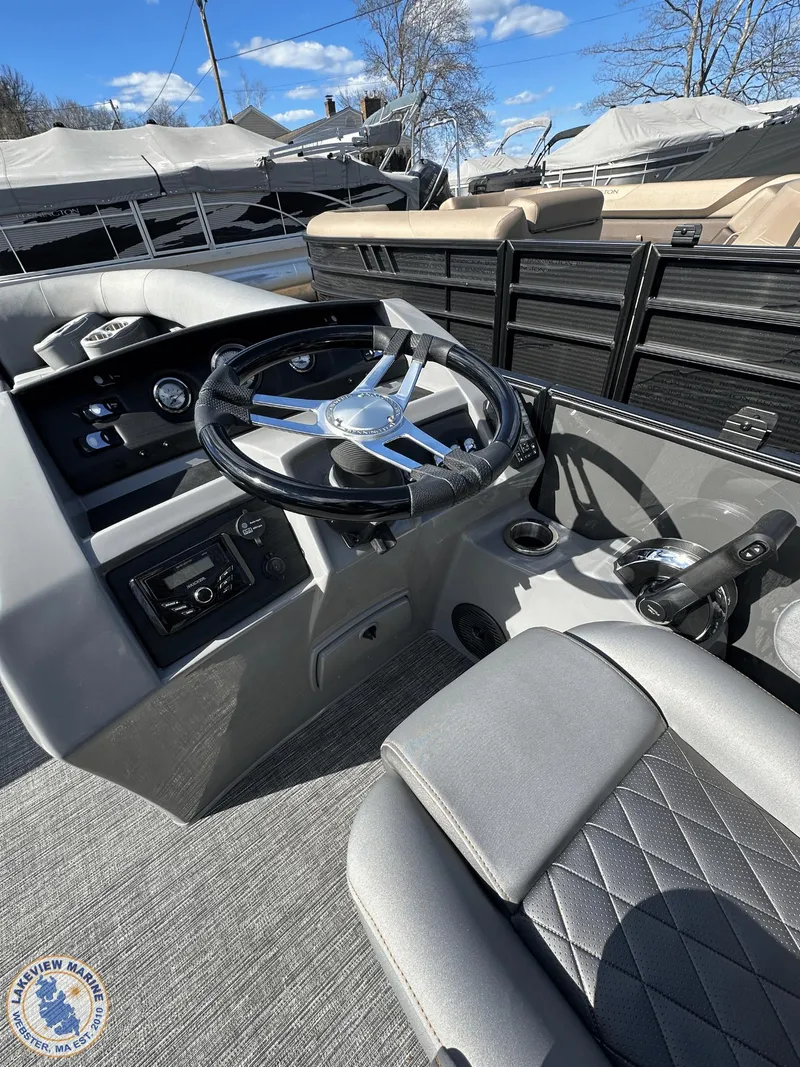 Slide: The Image of 2024 Bennington 23 LSR boat interior with steering wheel and seating. - 9