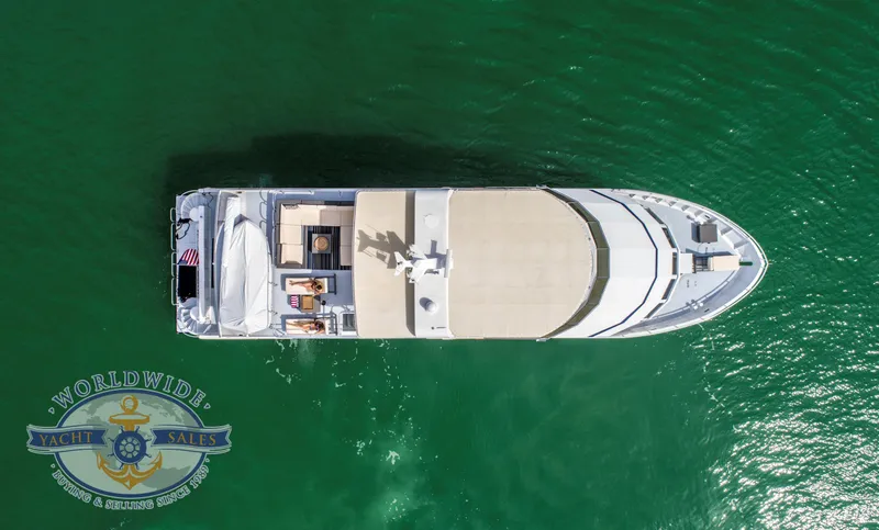 Slide: The Image of Aerial view of 2009 Custom Flybridge Motoryacht on green water. - 2
