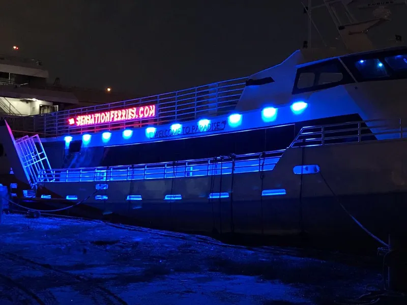 Slide: The Image of High-speed passenger ferry with blue lights, Midship Marine, 1981 model, docked at night. - 10