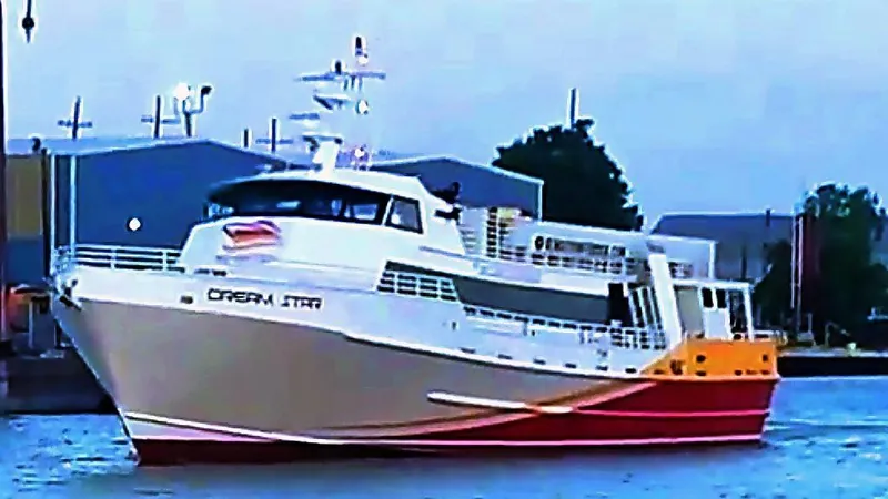 Slide: The Image of High-speed passenger ferry by Midship Marine, 1981, docked near industrial buildings. - 12