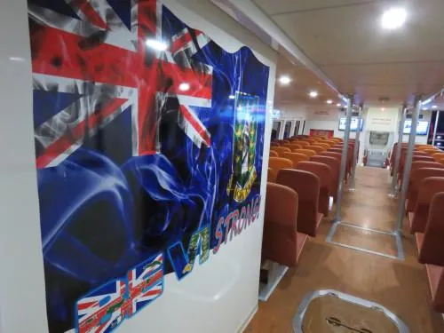 Slide: The Image of Interior of 1981 Midship Marine High Speed Passenger Ferry with flag decor and orange seating. - 17
