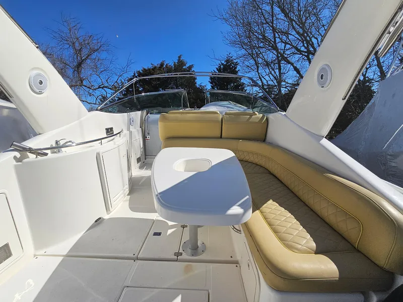 Slide: The Image of 2008 Riviera M470 yacht interior with beige seating and table under clear blue sky. - 10
