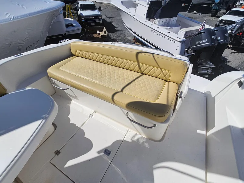 Slide: The Image of 2008 Riviera M470 boat with tan quilted seating in a marina setting. - 11