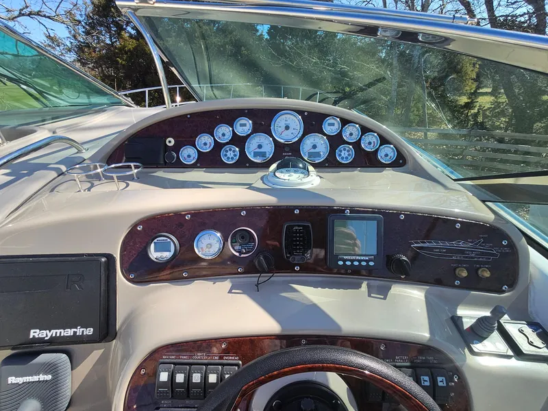 Slide: The Image of Dashboard of a 2008 Riviera M470 boat with gauges and navigation equipment. - 13