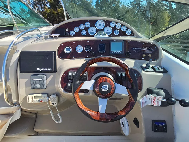 Slide: The Image of 2008 Riviera M470 boat dashboard with steering wheel, gauges, and navigation equipment. - 14