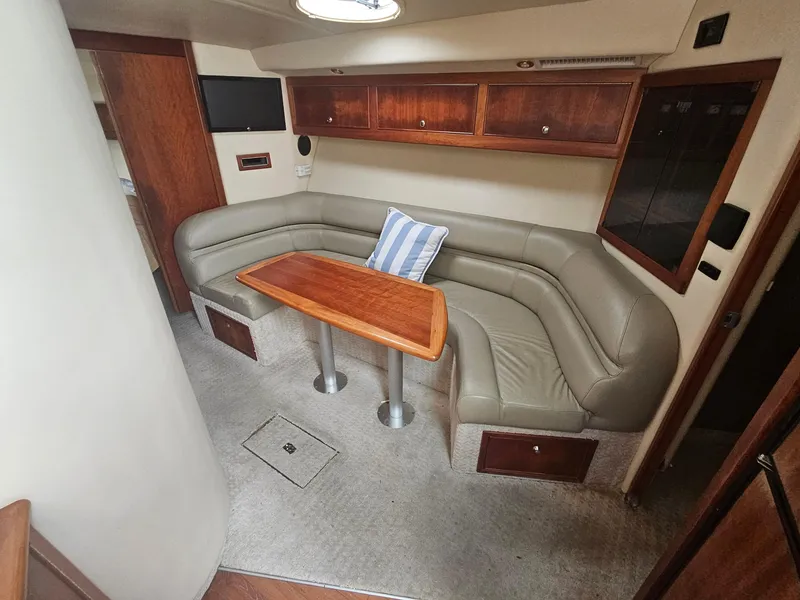 Slide: The Image of Luxurious interior of 2008 Riviera M470 yacht with leather seating and wooden table. - 19