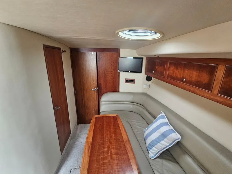 Slide: The Image of Interior of 2008 Riviera M470 yacht with wood accents and cozy seating area. - 20