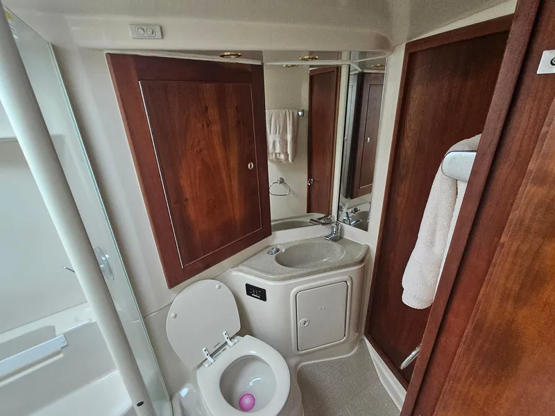 Slide: The Image of Luxurious 2008 Riviera M470 yacht bathroom with wooden cabinets and modern fixtures. - 21