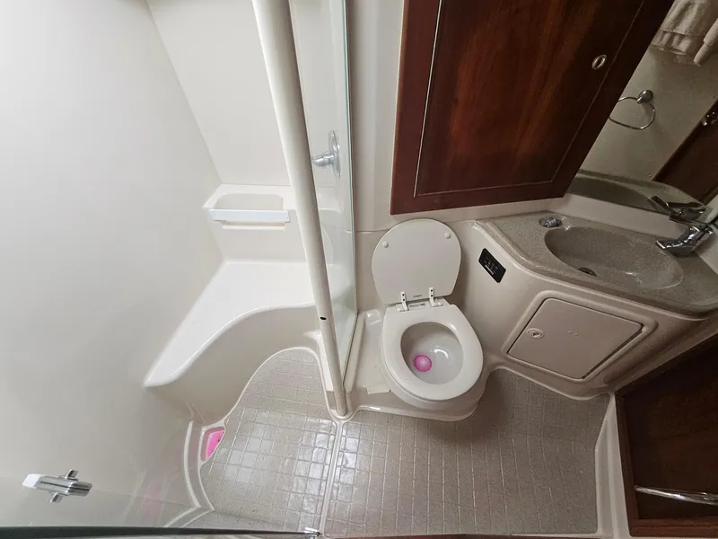 Slide: The Image of Compact bathroom in 2008 Riviera M470 yacht with shower, toilet, and sink. - 22