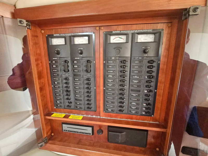 Slide: The Image of Electrical panel on a 2008 Riviera M470 boat, featuring multiple switches and meters. - 24