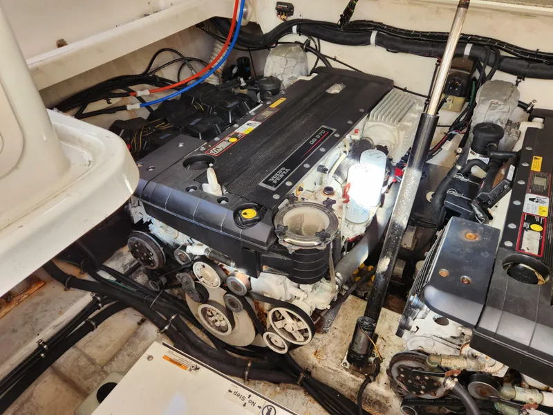 Slide: The Image of Engine compartment of a 2008 Riviera M470 boat, showcasing mechanical components and wiring. - 28