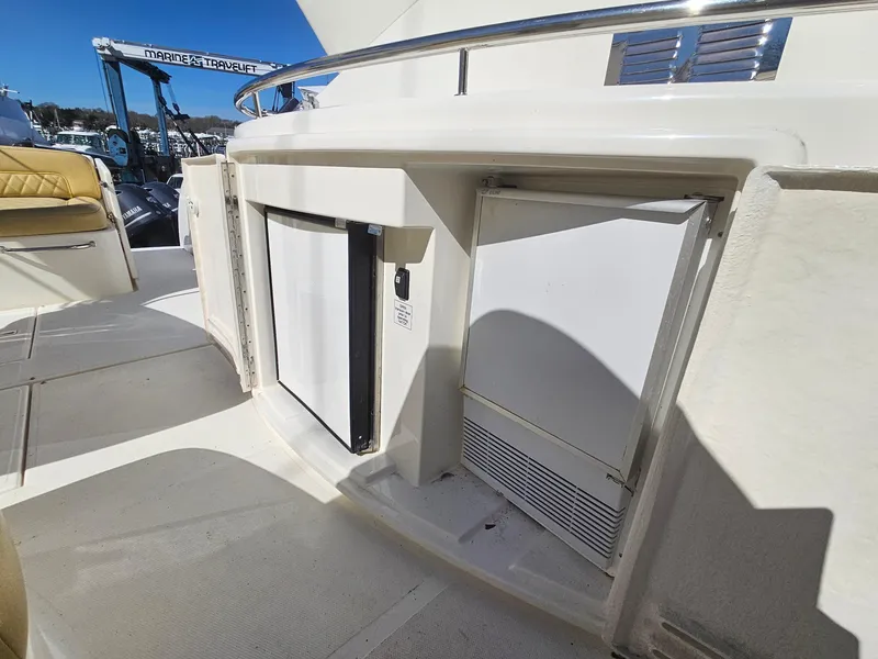 Slide: The Image of 2008 Riviera M470 yacht deck with built-in storage compartments and seating area. - 9