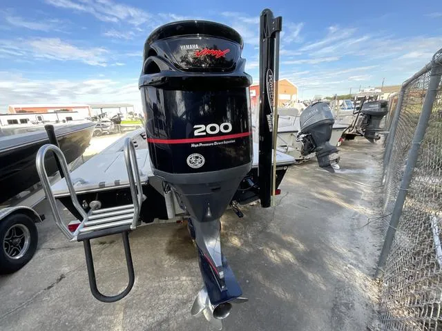 Slide: The Image of 2009 Pathfinder 2100 Fusion boat with Yamaha 200 outboard motor in a marina setting. - 12