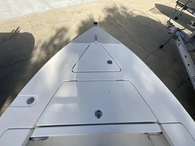 Slide: The Image of 2009 Pathfinder 2100 Fusion boat deck, white surface, storage compartments, outdoor setting. - 8