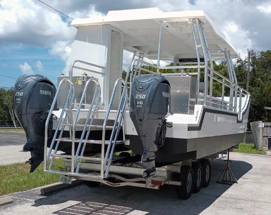 Slide: The Image of Custom 34 boat with dual Yamaha 250 V6 engines on a trailer, 2025 model. - 3
