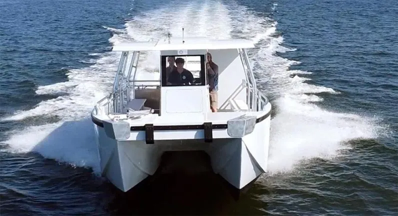 Slide: The Image of Custom 34 boat cruising on open water, 2025 model, front view. - 4